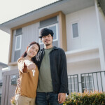 Couple holding house keys.